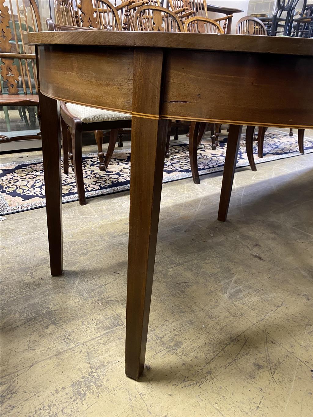 A George III mahogany D end dining table, on square tapered legs, with three spare leaves, 274cm extended, one spare leaf, width 107c